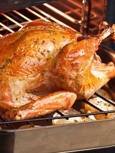 a roasting turkey is being cooked in an oven