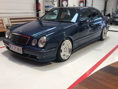 a blue car is parked in a garage