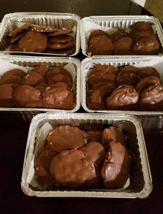 four pans filled with chocolate covered cookies on top of a table