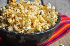 a bowl filled with popcorn sitting on top of a table