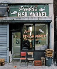 there is a fish market in front of the building that sells it's products