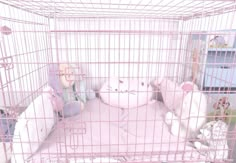 a pink cage with stuffed animals in it