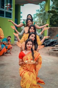 a group of women sitting on top of each other