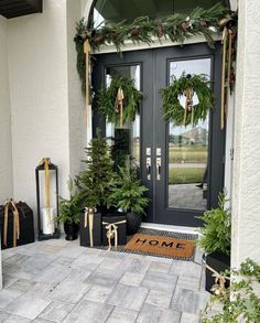 the front door is decorated for christmas with wreaths and pine cones on it's sides