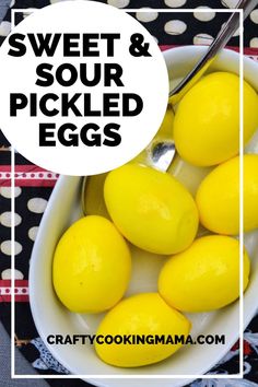 a white bowl filled with lemons on top of a black and white table cloth