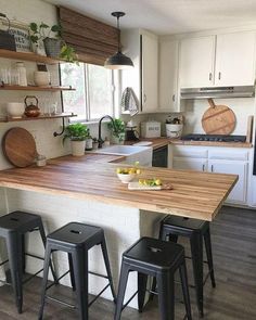 a kitchen island with three stools next to it