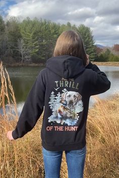 This hoodie is designed with the outdoorswoman in mind. Crafted from high-quality materials, it features a Labrador Retriever graphic and For the Thrill of the Hunt quote. Enjoy all your favorite outdoor activities in comfort and style. Introducing our Gildan Ultimate Heavy Blend Hoodie for cozy comfort! Being designed for everyday wear, this hoodie is made from a premium 50/50 cotton-polyester blend, enhancing durability, while also staying super comfortable. This cozy  hoodie provides warmth, a soft feel, and long-lasting comfort and durability.      The hood is double-lined with drawstrings for added warmth and an adjustable fit. Its double-needle stitching on the cuffs and waistband provides extra durability, while the spacious front pouch pocket offers convenience and functionality. T