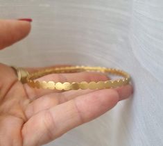 Gold bangles 14k, stacking bracelets gold, 14k gold bangle bracelet, vintage gold bracelet, 14k gold bridesmaid bracelet, bridal bangle bracelets Gold bangle 14k gold plated, made of small circles set in a row and soldered to one another, creating a vintage style hoop bracelet. This gold bracelet is 100% handmade and is unique and elegant. Dimensions: This gold, bridal bangle bracelet is available in 3 different sizes: Small (S), Medium (M) , Large (L) and Extra large (XL). Small - diameter of 6 Elegant Stackable Brass Bangle, Elegant Stackable Brass Bracelets, Delicate Stackable Wedding Bracelets, 14k Gold Wedding Cuff Bracelet, Gold Brass Bracelet For Wedding, Brass Gold Bracelet For Wedding, Yellow Gold Brass Cuff Bracelet For Weddings, Delicate Gold Bangle Bracelet, Gold 14k Wedding Bangle