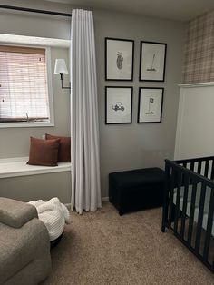 a baby's room with a crib, window and pictures on the wall