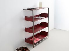 a pair of shoes sitting on the floor next to a shelf