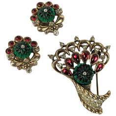 Trifari Jewels of India Moghul Set circa 1949 by Alfred Phillipe. Scroll brooch with pave accents with matching clip earrings. Fluted faux emeralds with ruby pears shaped stones in rose gold plate. Brooch 1.75" x 1.25", Earrings 7/8" x 5/8". Trifari Brooch, 1960s Jewelry, Trifari Jewelry, Book Pieces, Vintage Trifari, Crown Trifari, Vintage Jewels, Vintage Costume Jewelry, Vintage Costumes