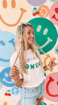 a girl with long blonde hair is smiling and holding a toothbrush in her hand