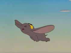 an elephant flying through the air with its trunk in it's mouth and eyes closed