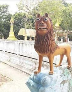 a statue of a lion on top of a rock