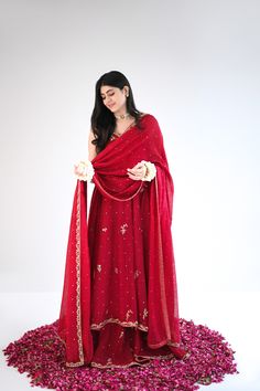 Designed on a beautiful tone of maroon in handloom cotton net, this panelled kalidaar features gold ada work of dabka naqshi, sequins and nug. An alluring three piece is paired with a heavily embellished dupatta and flappers. The length of the kalidaar is 46 inches. Order Duration: 4 to 6 weeks Traditional Jamawar Dress With Mirror Work, Festive Raw Silk Lehenga With Dabka Details, Festive Unstitched Suit With Dabka And Traditional Drape, Bollywood Style Dabka Lehenga In Jamawar, Festive Floor-length Jamawar Sharara, Straight Kurta With Dabka And Kundan, Elegant Jamawar Dupatta With Mirror Work, Unstitched Raw Silk Lehenga With Dabka, Unstitched Raw Silk Lehenga With Dabka Detail