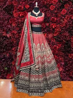 Indulge in the elegant grandeur of our traditional lehenga, crafted for the modern woman. Our enchanting Sirat Lehenga radiates sophistication and exclusivity, adorned with exquisite embroidery work, precious mirrors, pearls, and stones. With a timeless Ruby Red hue, this ensemble exudes grace and luxury, perfect for weddings and bridal occasions. Step into the luxurious world of exclusive Indian fashion with our Sirat Lehenga, a mesmerizing fusion of tradition and modernity, elevated by intrica Designer Kundan Lehenga With Intricate Embroidery, Embroidered Kundan Gown With Traditional Drape, Kundan Choli With Intricate Embroidery For Reception, Elegant Art Silk Lehenga In Traditional Drape, Navratri Kundan Gown With Intricate Embroidery, Elegant Kundan Gown With Pallu, Designer Embroidered Lehenga In Chinon, Designer Raw Silk Lehenga With Intricate Embroidery, Designer Embroidered Chinon Lehenga