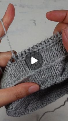 someone is knitting something with their fingers