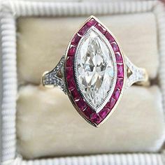 a fancy ring with an oval cut diamond and pink tourmaline in the center