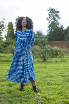 An elegant 100% organic cambric cotton summer dress.  Crafted from indigo dyed dabu block prints. Designed in England and printed in India. We pour a lot of love into our block printed dresses. Each one is made from super soft organic cotton and  fully traceable back to our lovely printers in Jaipur India. FEATURES Organic cotton Easy pull on over the head style. Scooped neckline with tie and coconut button down detail Mid arm lantern sleeves with contrast cuff and coconut buttons Mid calf length shirt tail hem In seam side pockets CARE Pre washed. Wash separate first wash. Handwash or wash cool. Do not tumble. Line dry. Hot iron. Made in a small batch. Once they are gone they're gone . Well crafted. Low environmental impact. Small batch production. Sizing Guide   UK SIZING  MODEL IS A UK Blue Summer Dress With Natural Dye, Blue Block Print Midi Dress For Summer, Summer Indigo Cotton Maxi Dress, Indigo Cotton Midi Length Dress, Blue Bohemian Dress With Bandhani Print, Indigo Bohemian Dress With Batik Print, Blue Cotton Maxi Dress With Batik Print, Blue Cotton Dress With Batik Print, Indigo Bohemian Cotton Dress