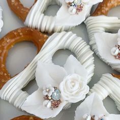 there are many decorated pretzels with flowers on the top one is made out of white icing