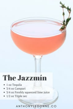 the jazzmin cocktail is served in a coupe glass with a sprig of rosemary