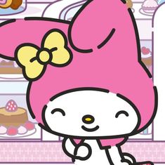 hello kitty is standing in front of the refrigerator