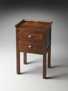 a small wooden table with two drawers on one side and an open drawer on the other