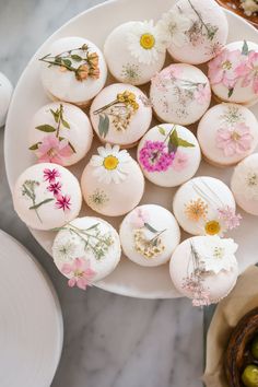 a plate with flowers on it next to other plates and bowls filled with food items