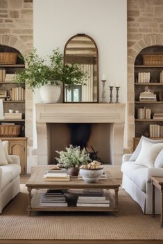 a living room with two couches and a coffee table in front of a fireplace