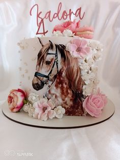 a birthday cake with a horse and flowers on it