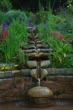 a water feature in the middle of a garden