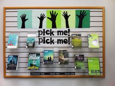 there is a sign that says pick me, pick me on the wall with many books