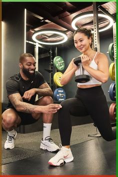 a man and woman squatting down in the gym