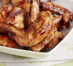 chicken wings with sauce in a white bowl