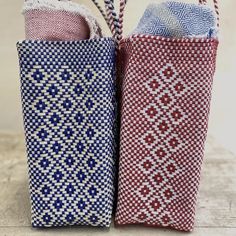 two red, white and blue bags sitting next to each other