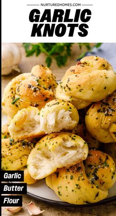 garlic knots on a plate with garlic florets in the background