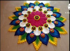 a colorful flower made out of paper sitting on top of a table