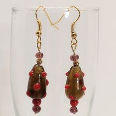 Hand Crafted Earrings. Glass Beads In Amber/Brown With Dark Red Dots, Red, And Smoky Brownish Lavender. Gold Tone Hardware And Accent Bead. J-Hook Style. Picture With Aaa Battery For Size Comparison. 2 1/8 Inches Drop Smoke Free, Pet Free Home. Handmade Jewelry Brown Dangle Beaded Earrings With Colorful Beads, Colorful Brown Beaded Dangle Earrings, Brown Large Beads Dangle Earrings, Brown Dangle Earrings With Colorful Beads, Amber Beaded Dangle Earrings, Beachy Earrings, Statement Earrings Wedding, Crystal Pearl Earrings, Elephant Earrings