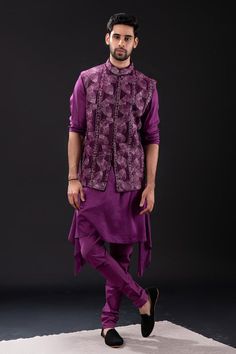 Purple sleeveless bundi with all over foliage embroidery. Paired with long sleeves asymmetric hem kurta and matching churidar.
Components: 3
Pattern: Embroidered
Type Of Work: Foliage
Neckline: Mandarin Collar
Sleeve Type: Bundi: Sleeveless, Kurta: Long
Fabric: Mal Cotton, Raw Silk, Cotton Lycra
Color: Purple
Other Details: 
Approx weight: 2kgs
Poly lining
Occasion: Mehendi and Puja, Sangeet - Aza Fashions Foliage Embroidery, Purple Foliage, Sleeveless Kurta, Kurta Set For Men, Nehru Jackets, Churidar, Kurta Set, Raw Silk, Mandarin Collar