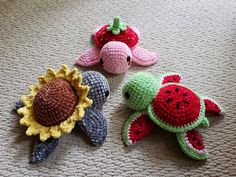 three crocheted stuffed animals are laying on the floor next to eachother