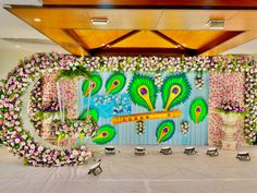 a decorated stage with flowers and peacocks on it