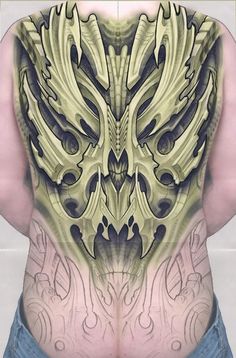 the back of a man's body with intricate designs on his chest and lower back