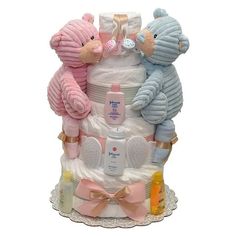 a diaper cake with teddy bears and baby items on it's bottom tier