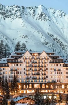 the hotel is surrounded by snowy mountains and trees