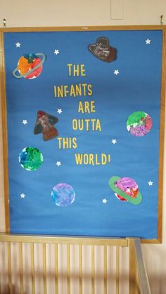 a bulletin board that says the infants are outa this world