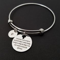 "Serenity Prayer Bracelet Personalized Initial Bangle Bracelet! A round charm printed with Serenity Prayer beginning with \"Lord grant me the serenity\" on a stainless steel expandable bangle bracelet makes the perfect gift for you or a loved one. God, grant me the serenity to accept the things I cannot change, Courage to change the things I can, And wisdom to know the difference. The religious bracelet charm is made from stainless steel and measures 24 mm by 24 mm. The bible verse bracelet is h Metal Circle Bracelets As Gift, Metal Bracelets As Gift, Metal Bracelets Gift, Adjustable Hypoallergenic Round Name Bracelet, Adjustable Hypoallergenic Name Bracelet, Stainless Steel Friendship Bangle, Adjustable Round Spiritual Bangle, Spiritual Round Stainless Steel Bracelets, Adjustable Round Jubilee Stretch Bracelet