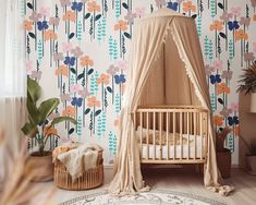 a baby's room with floral wallpaper and a crib