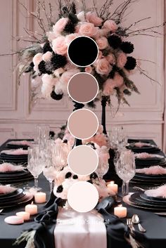 the table is set with black, white and pink flowers in shades of gray on it