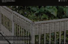 a white wicker fence with the words canfield edging on it's side