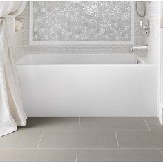 a white bath tub sitting next to a window